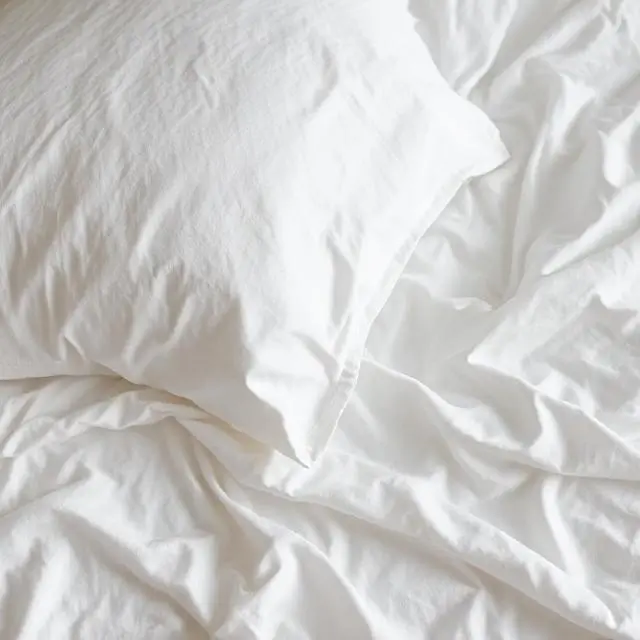 Crisp linen sheets on a bed
