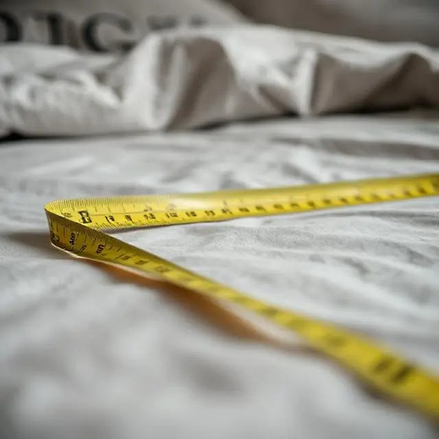 Close-up of a tape measure on a bed